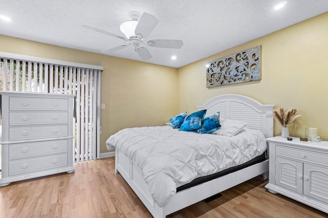 bedroom featuring a textured ceiling, ceiling fan, and light hardwood / wood-style flooring