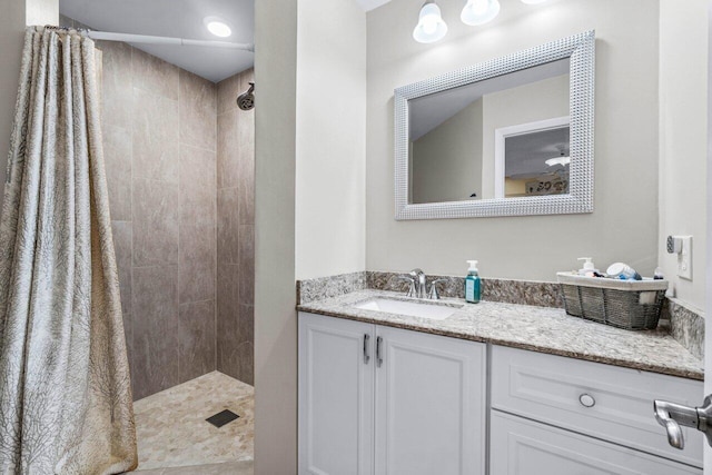 bathroom featuring a shower with shower curtain and vanity