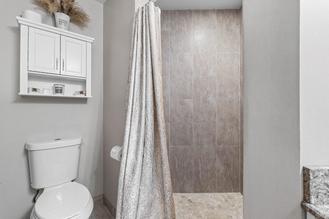 bathroom with a shower with curtain and toilet