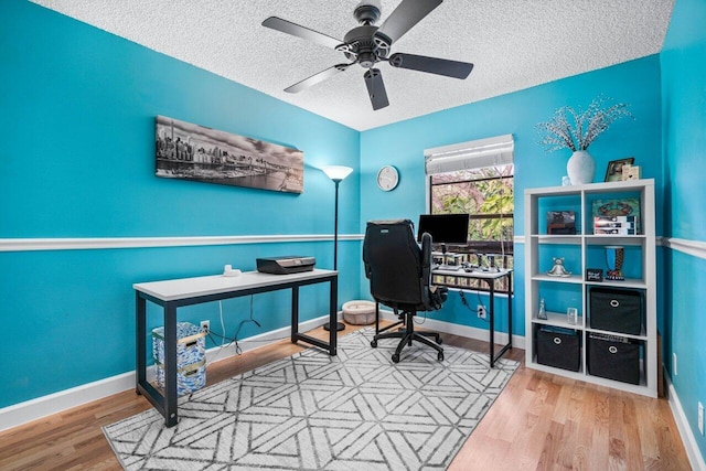 office space featuring a textured ceiling, hardwood / wood-style floors, and ceiling fan