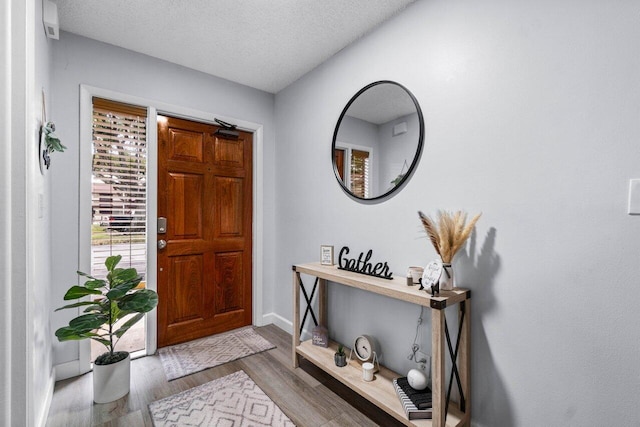 entrance foyer featuring a textured ceiling and light hardwood / wood-style flooring