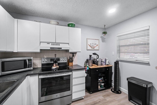 kitchen with a textured ceiling, stainless steel appliances, light hardwood / wood-style floors, tasteful backsplash, and white cabinetry