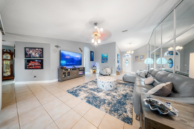 tiled living room with ceiling fan with notable chandelier and lofted ceiling