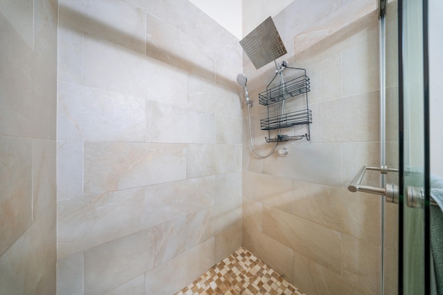 bathroom featuring a shower with door