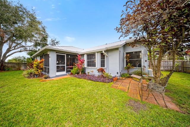 view of front of home featuring a front yard and a sunroom