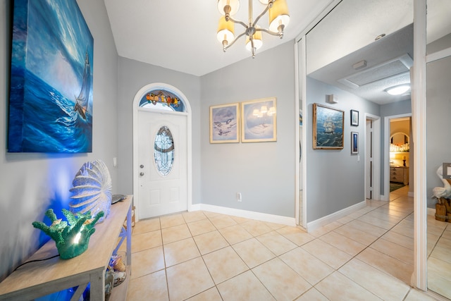 foyer with an inviting chandelier and light tile patterned floors