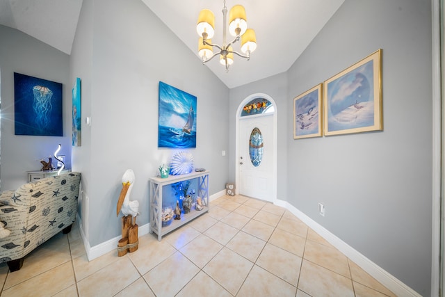 foyer entrance featuring light tile patterned flooring, a chandelier, and vaulted ceiling