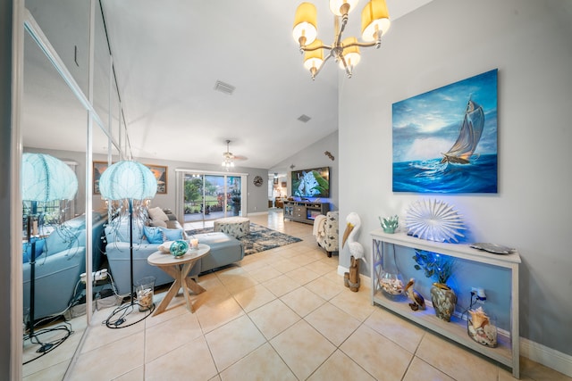 living room featuring ceiling fan with notable chandelier, vaulted ceiling, and light tile patterned floors