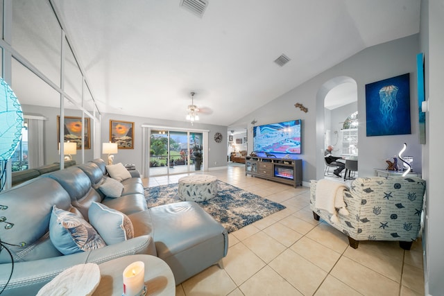 living room featuring lofted ceiling, ceiling fan, and light tile patterned floors