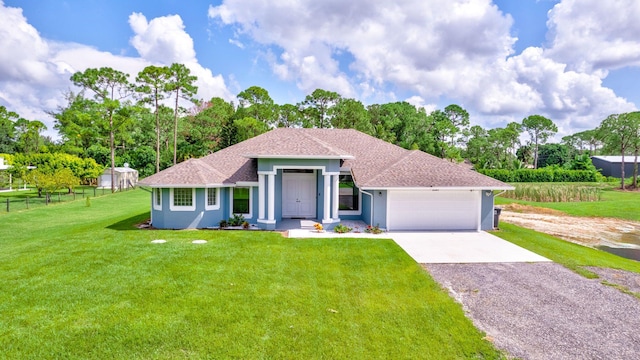 view of front of property with a front lawn and a garage