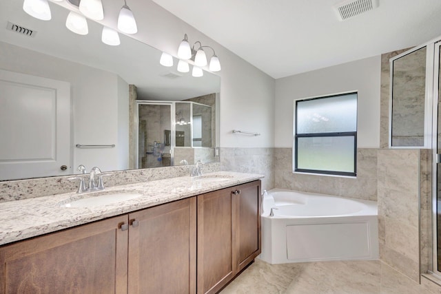 bathroom with tile patterned flooring, vanity, tile walls, and independent shower and bath