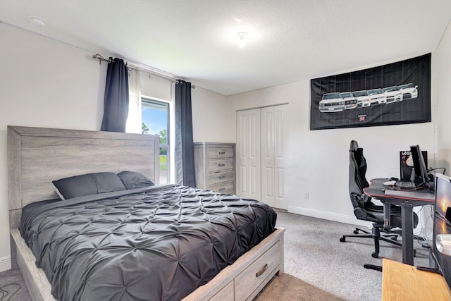 bedroom featuring a closet, carpet floors, and a textured ceiling