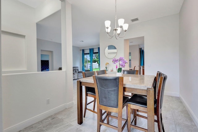 tiled dining space featuring an inviting chandelier