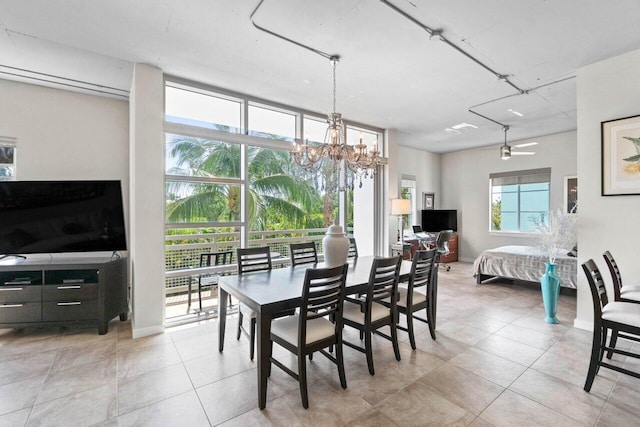 dining space with ceiling fan with notable chandelier and light tile patterned flooring