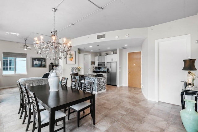 dining room with ceiling fan and sink