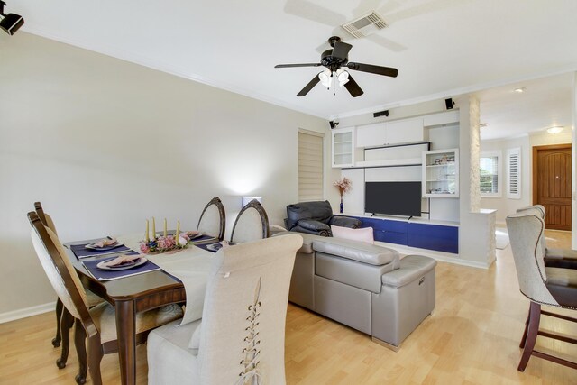 living room featuring hardwood / wood-style floors, ornamental molding, and a notable chandelier