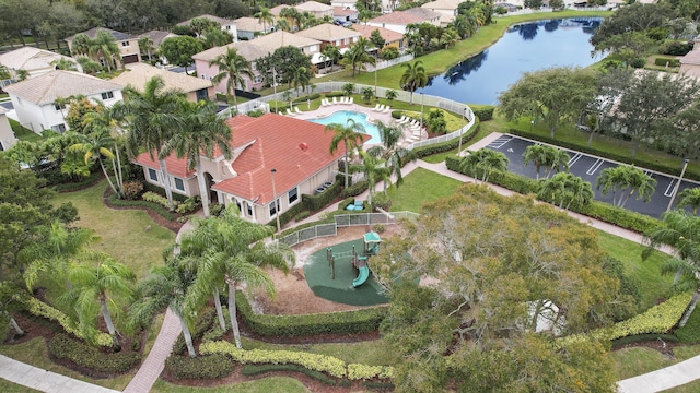 birds eye view of property with a water view and a residential view