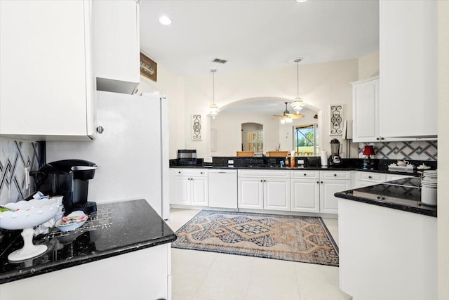 kitchen with backsplash, white cabinetry, dishwasher, and hanging light fixtures