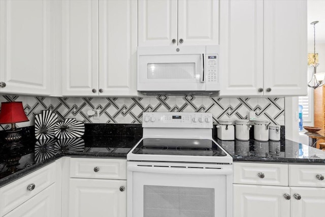 kitchen featuring tasteful backsplash, dark stone countertops, white cabinetry, and white appliances