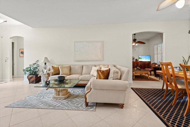 tiled living room with ceiling fan