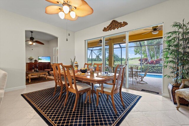 tiled dining space with ceiling fan