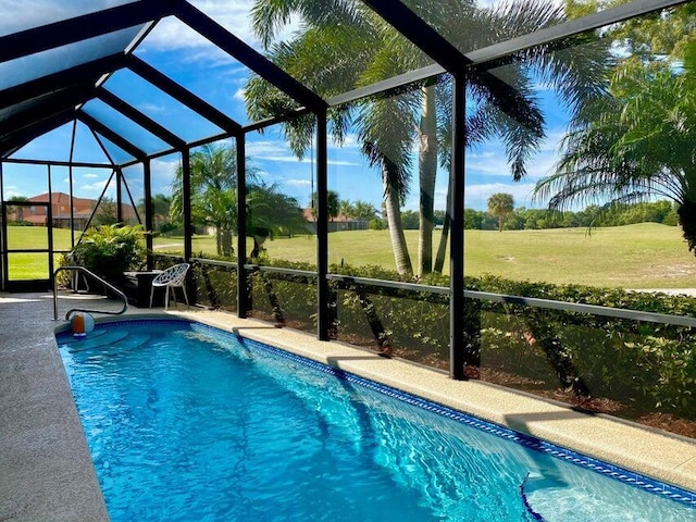 view of swimming pool featuring a lanai