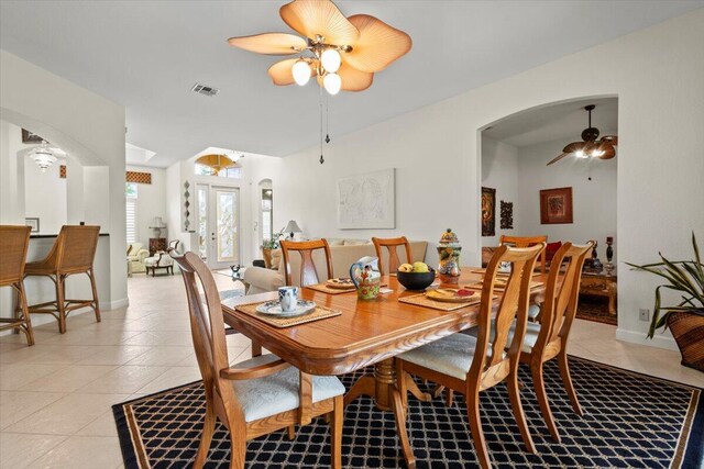 dining room with ceiling fan, french doors, and light tile patterned flooring