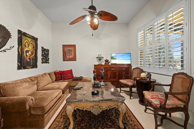 living room featuring ceiling fan, light tile patterned floors, and a healthy amount of sunlight