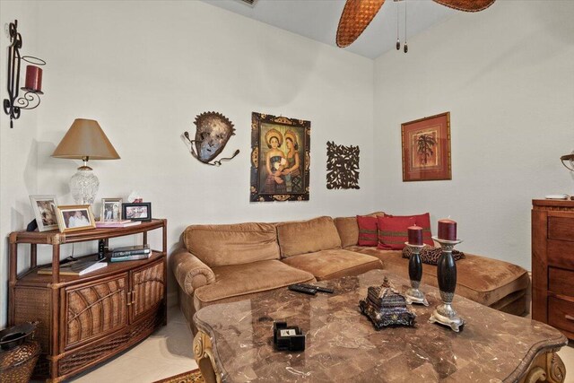 tiled living room with ceiling fan