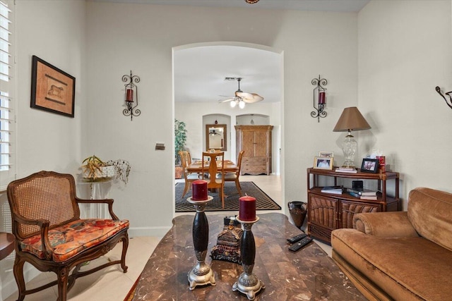 living room with ceiling fan and light tile patterned floors