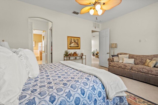 bedroom featuring ensuite bath and ceiling fan