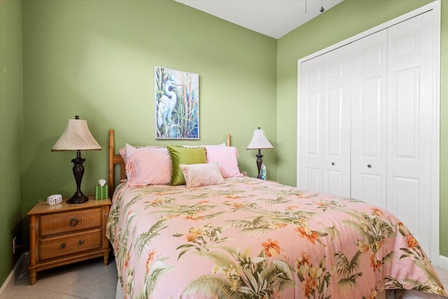 tiled bedroom with a closet