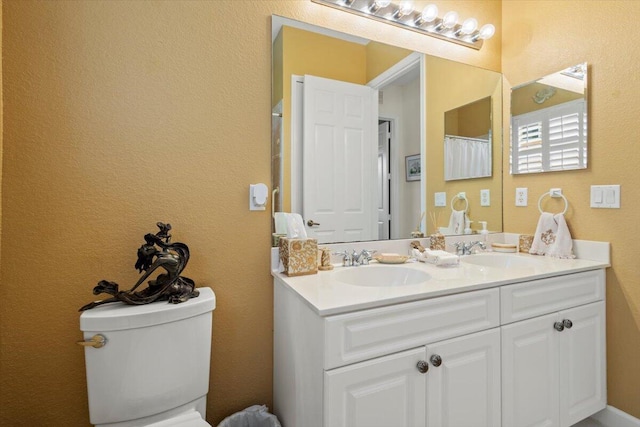 bathroom featuring vanity and toilet