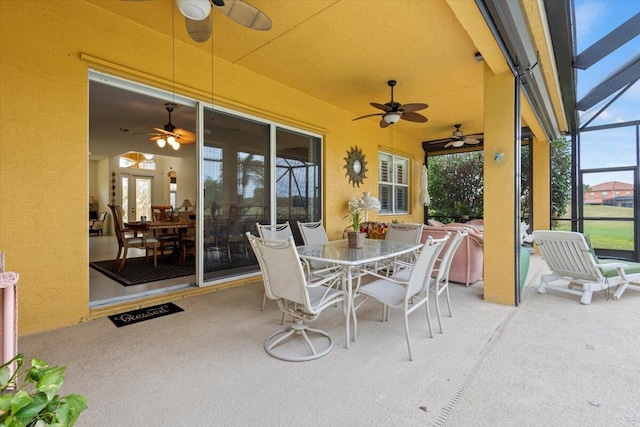 view of patio featuring glass enclosure