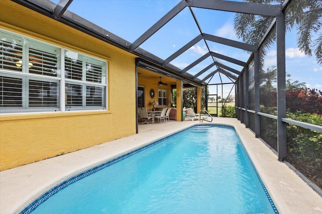 view of pool featuring a patio, ceiling fan, and a lanai