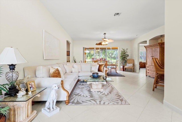 tiled living room with ceiling fan