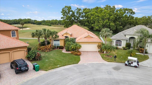 mediterranean / spanish-style house featuring a front lawn and a garage