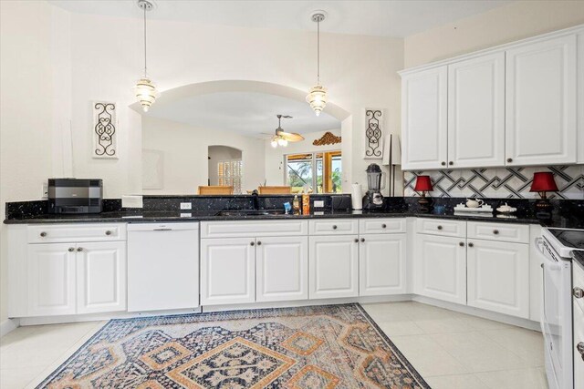 kitchen featuring white cabinets, pendant lighting, and white appliances