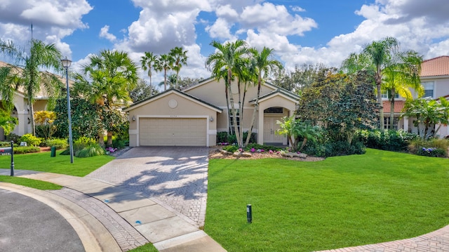 4174 Bahia Isle Cir, Wellington, FL 33449 - view of front facade with a garage, stucco siding, a front lawn, and decorative driveway