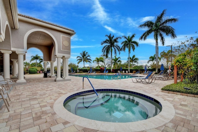 view of pool featuring a patio area and a hot tub