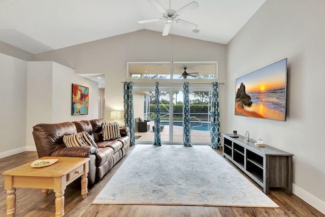 living room with hardwood / wood-style flooring, high vaulted ceiling, and ceiling fan