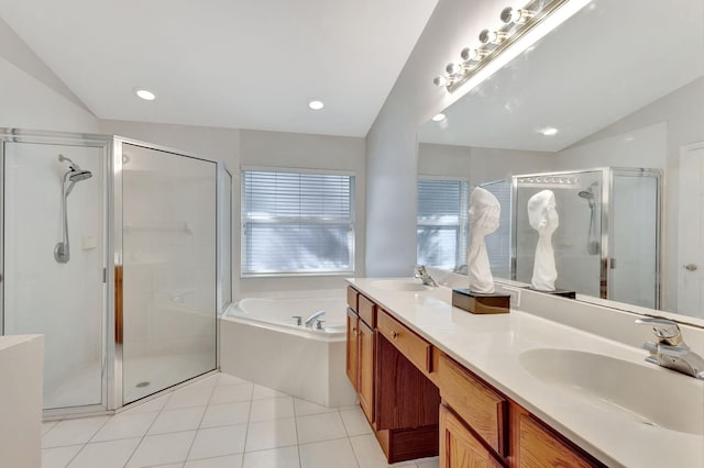 bathroom with tile patterned flooring, vanity, separate shower and tub, and vaulted ceiling