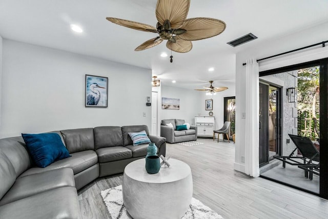 living room with ceiling fan and light hardwood / wood-style floors