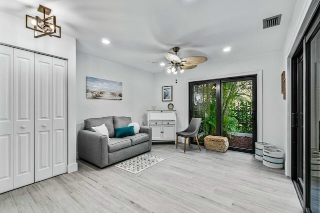 living area featuring ceiling fan and light hardwood / wood-style flooring