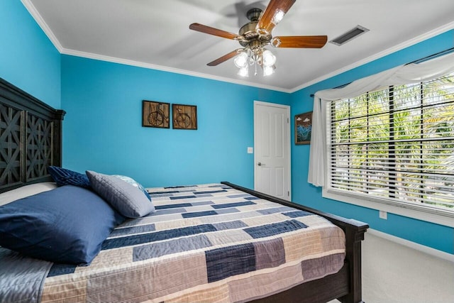 carpeted bedroom featuring ceiling fan and ornamental molding