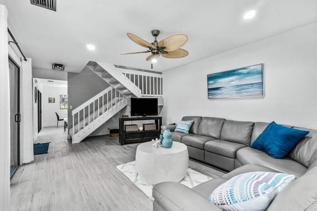 living room featuring ceiling fan and light wood-type flooring