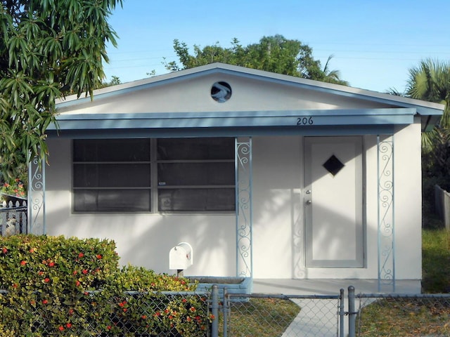 view of front facade with a fenced front yard and stucco siding