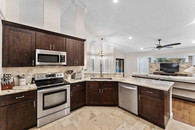 kitchen featuring sink, hanging light fixtures, dark brown cabinets, kitchen peninsula, and stainless steel appliances