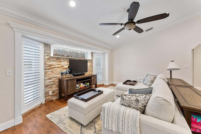 living room with crown molding, hardwood / wood-style floors, and ceiling fan