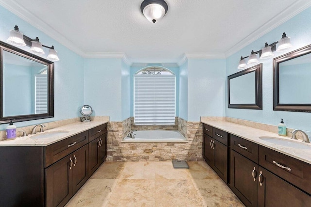 bathroom with vanity, a relaxing tiled tub, a textured ceiling, and ornamental molding